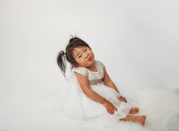 Toddler poses for holiday photo in studio