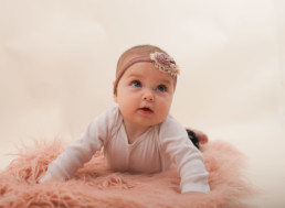 Toddler in studio photo shoot in Pasadena, California with pink decorative rug