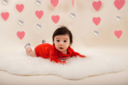 Baby in studio photo shoot in Pasadena, California with valentine day backdrop